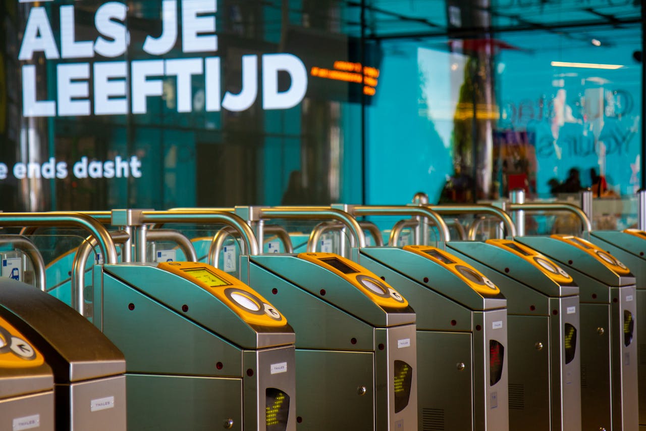 Modern ticket gates at an Amsterdam metro station showcasing urban transit technology.